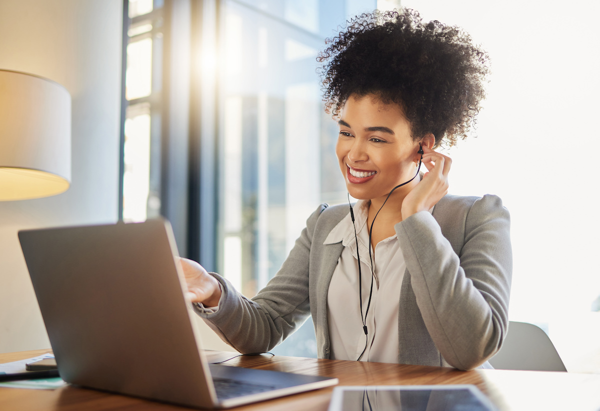 Woman going through a training program on her laptop in a corporate setting. 