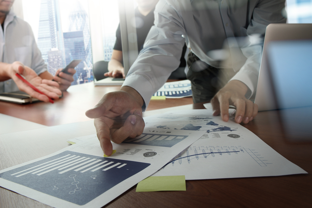 Man pointing to documents on a table