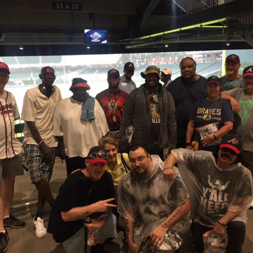 group of people taking picture inside of Atlanta braves baseball stadium