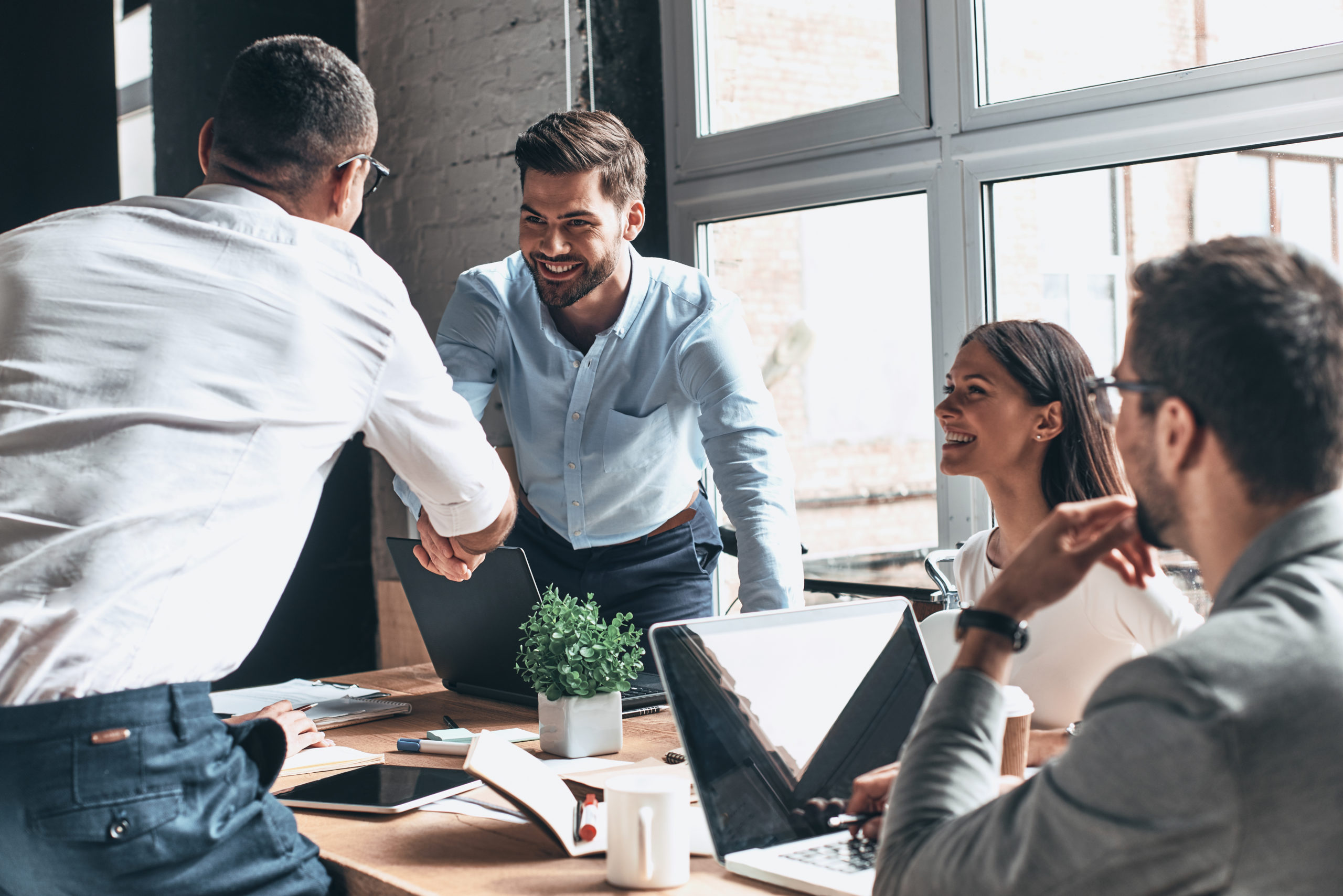 A business team working together on a project in a corporate setting.